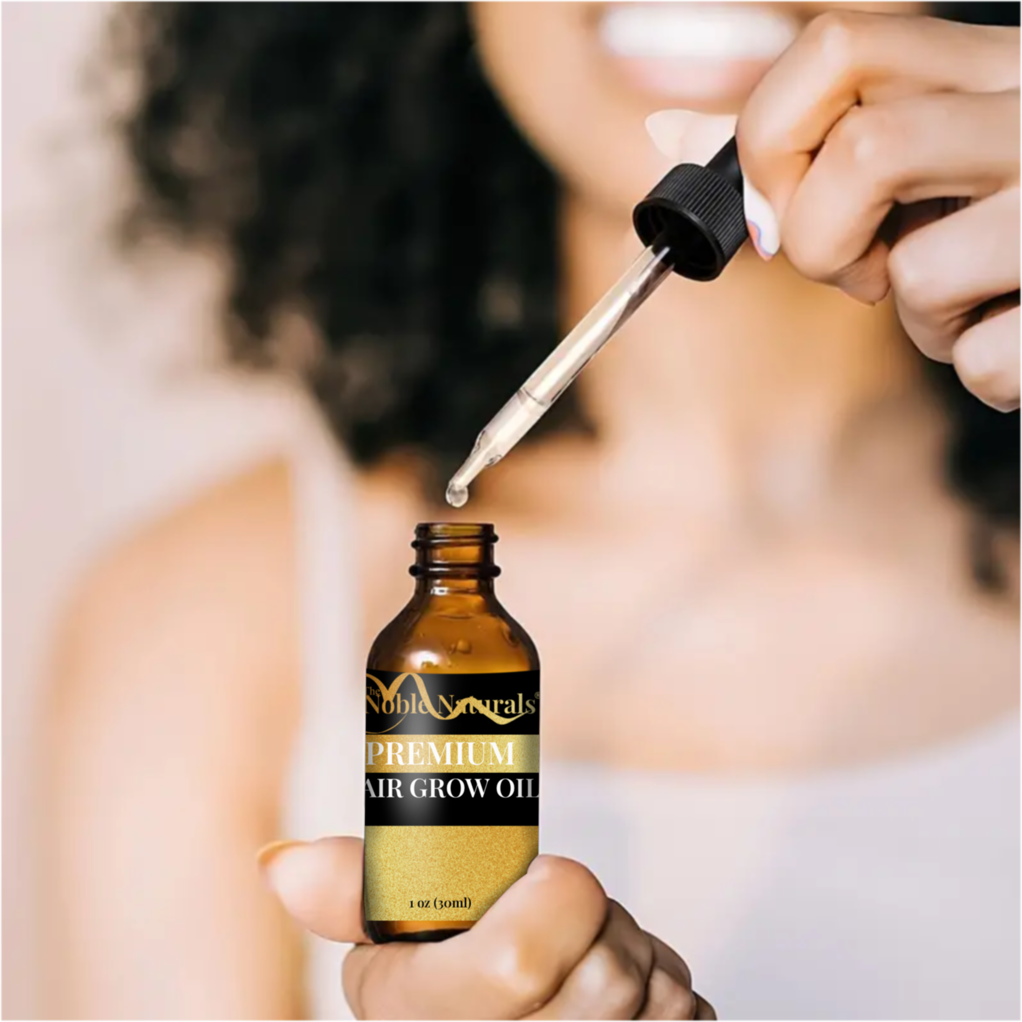 Person using a dropper to add oil from a bottle labeled 'Premium Hair Grow Oil' into a bottle.