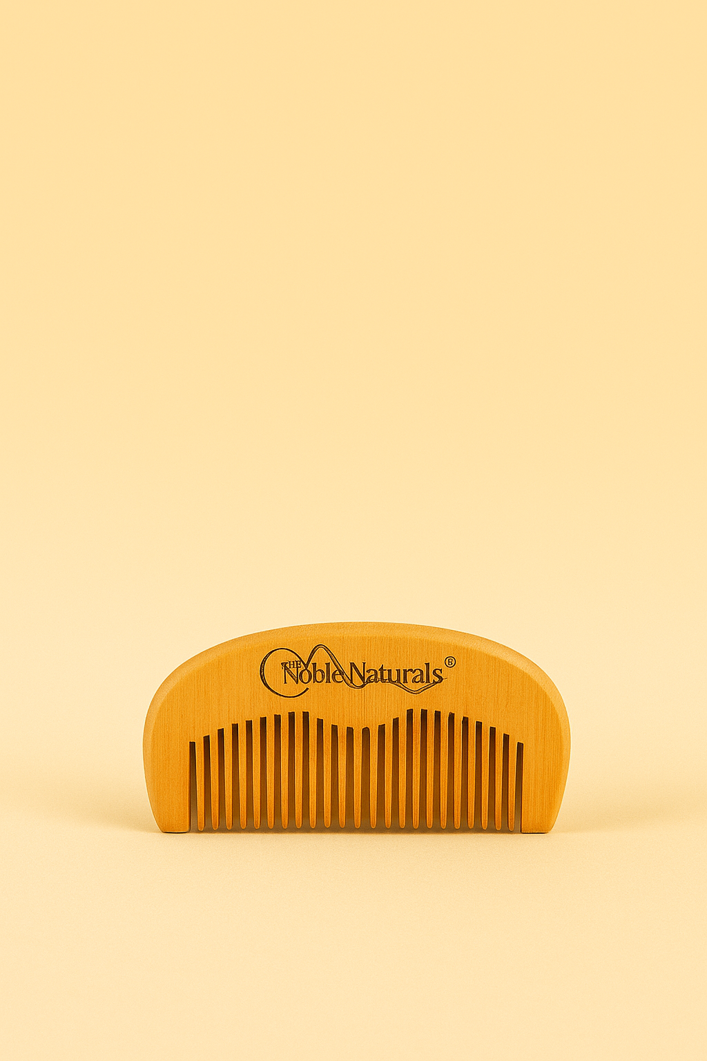 A wooden grooming comb engraved with the Noble Naturals™ logo, designed for natural hair care and healthy scalp maintenance.